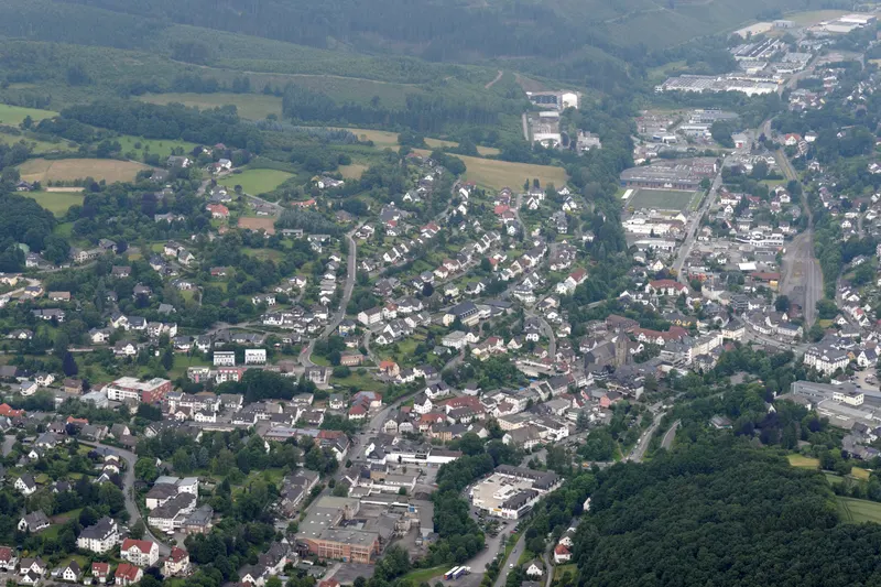 Staden Sundern sedd från luften, hus längs Röhr-dalen mellan skogsklädda kullar