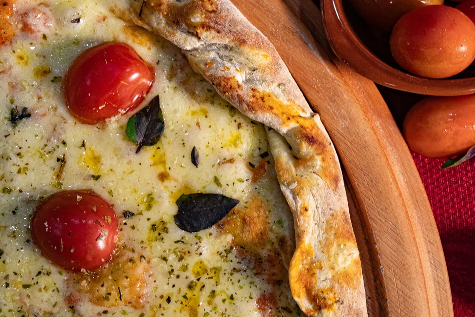 BookNoFees: Exempelbild: Ostpizza toppad med körsbärstomater